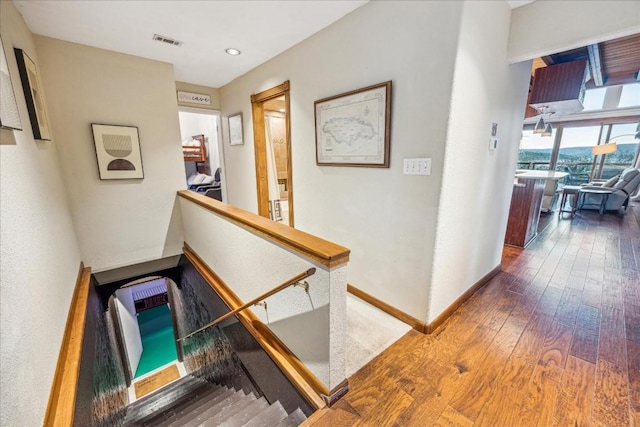 corridor featuring heating unit and dark hardwood / wood-style flooring