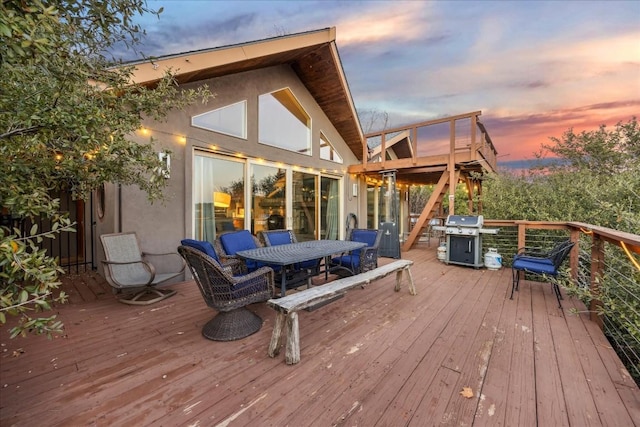 deck at dusk featuring area for grilling