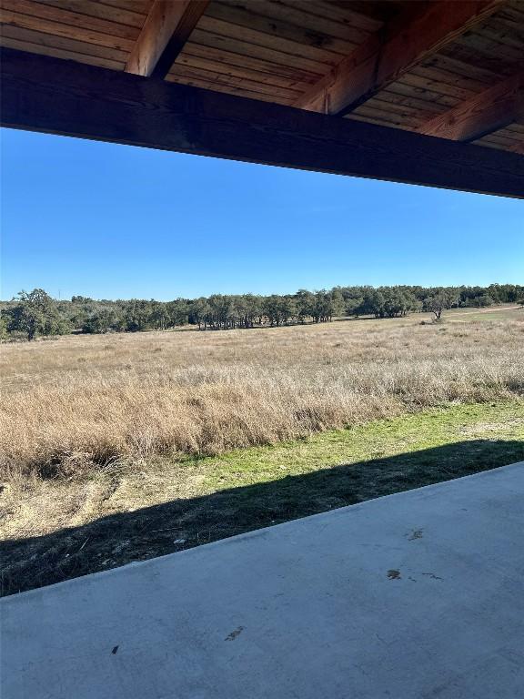 view of yard with a rural view and a patio