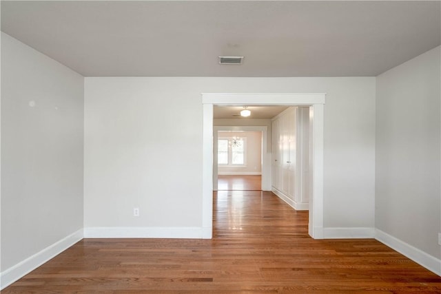 unfurnished room featuring hardwood / wood-style flooring