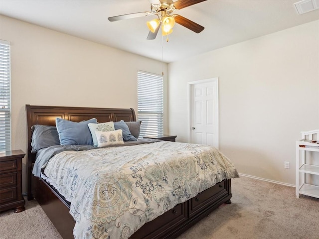 bedroom with light carpet, baseboards, visible vents, and a ceiling fan