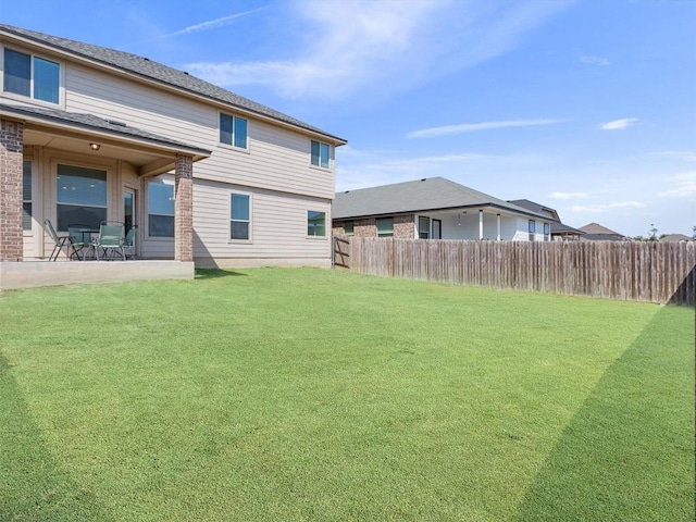 view of yard featuring a patio and fence