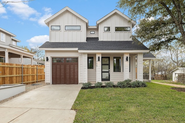 view of front facade with a porch, a front lawn, and a garage