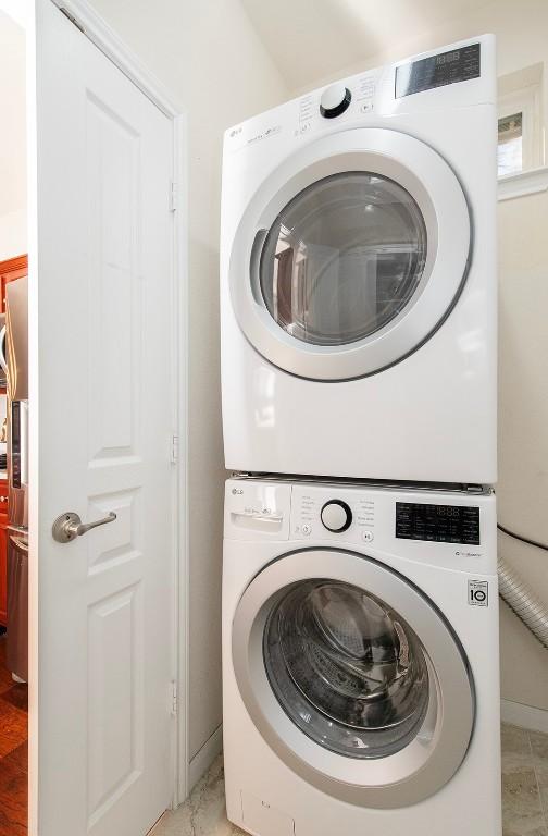 laundry room featuring stacked washer and dryer