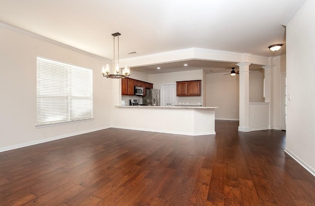 kitchen featuring pendant lighting, ceiling fan with notable chandelier, ornamental molding, kitchen peninsula, and stainless steel appliances