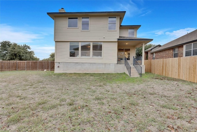 rear view of house with a yard