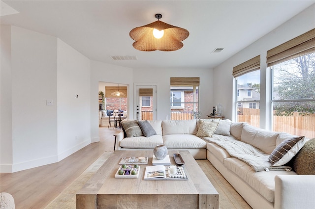 living room with ceiling fan and light hardwood / wood-style floors