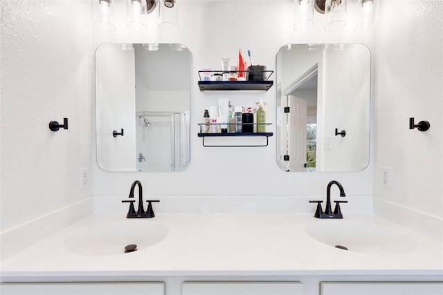 bathroom with a shower with door and vanity