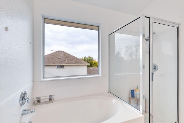 bathroom with shower with separate bathtub