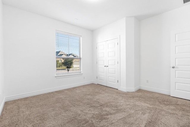 unfurnished bedroom with a closet and carpet