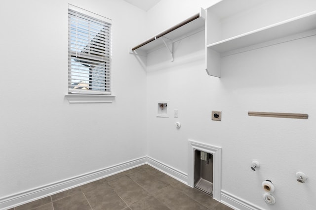 clothes washing area with washer hookup, hookup for a gas dryer, electric dryer hookup, and dark tile patterned flooring