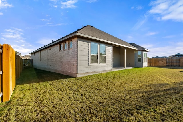 rear view of house with a yard