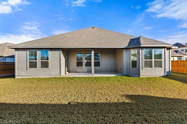 rear view of house with a patio area and a lawn