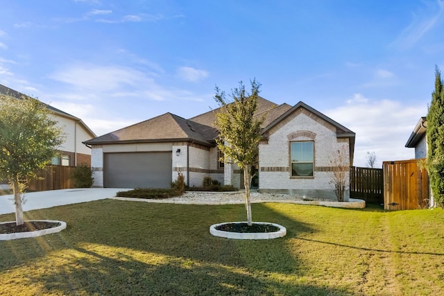 view of front of property featuring a garage and a front yard