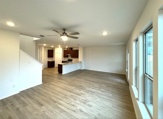 unfurnished living room with ceiling fan and hardwood / wood-style floors