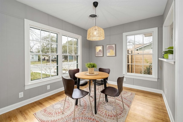 dining area with a healthy amount of sunlight and light hardwood / wood-style flooring