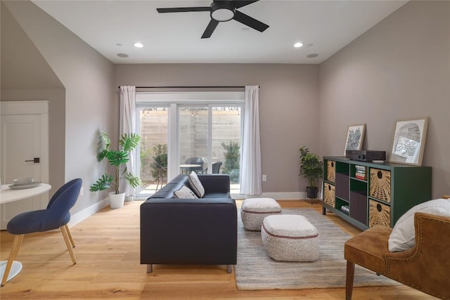 living room featuring ceiling fan and light wood-type flooring