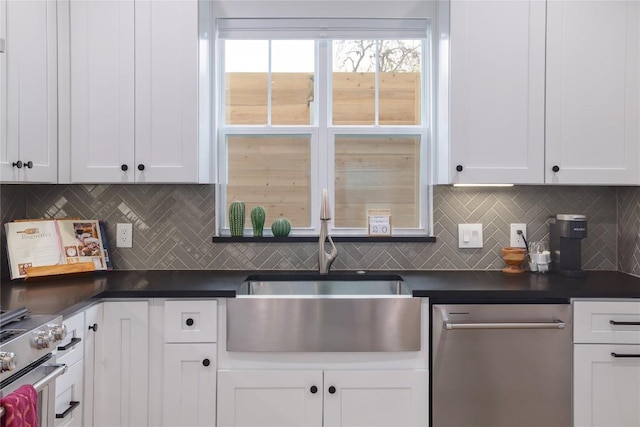 kitchen featuring white cabinets, backsplash, and stainless steel appliances