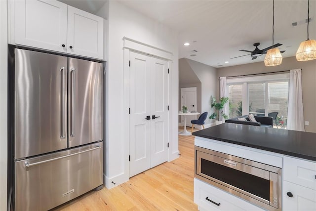 kitchen featuring ceiling fan, white cabinetry, appliances with stainless steel finishes, and light hardwood / wood-style flooring