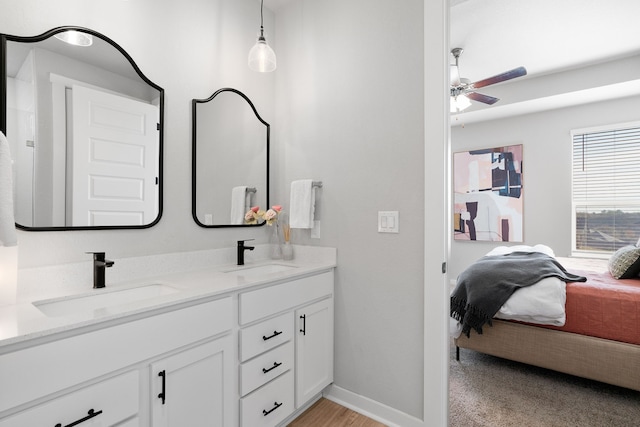 full bathroom with ensuite bathroom, double vanity, ceiling fan, and a sink