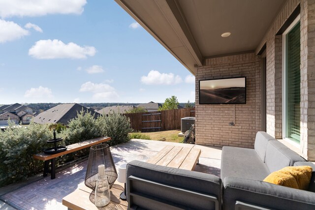 view of patio / terrace featuring fence, an outdoor living space, and cooling unit