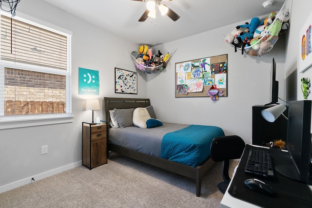 bedroom featuring ceiling fan, baseboards, and light colored carpet