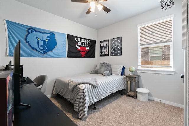 carpeted bedroom with ceiling fan and baseboards