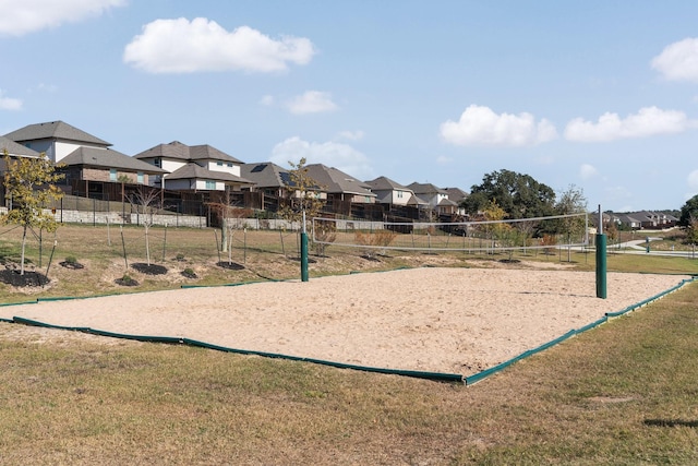 view of home's community with volleyball court, a yard, fence, and a residential view