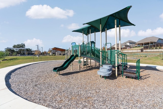 community jungle gym with a lawn