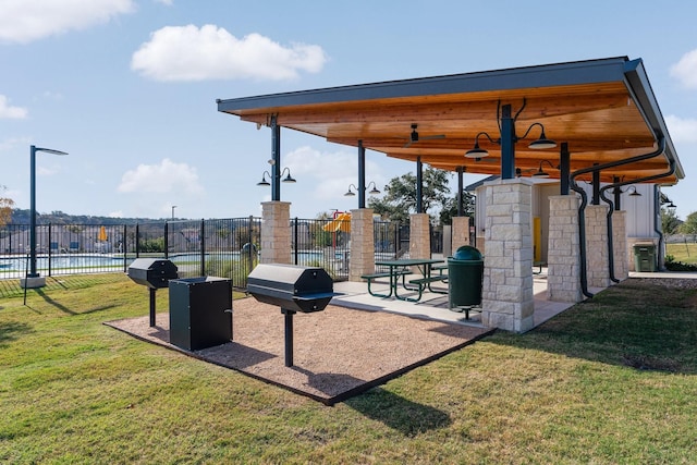 surrounding community with fence and a lawn