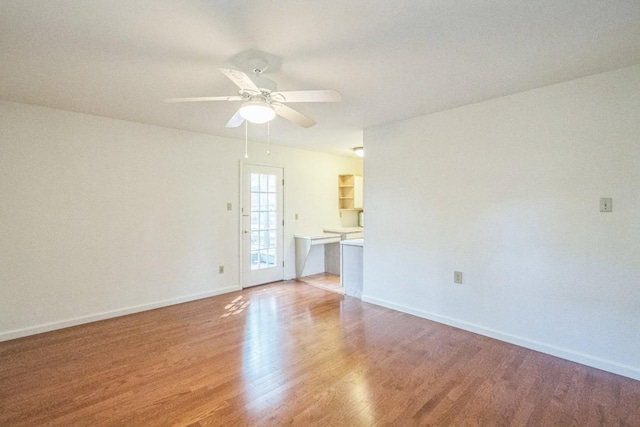 unfurnished room with hardwood / wood-style flooring and ceiling fan