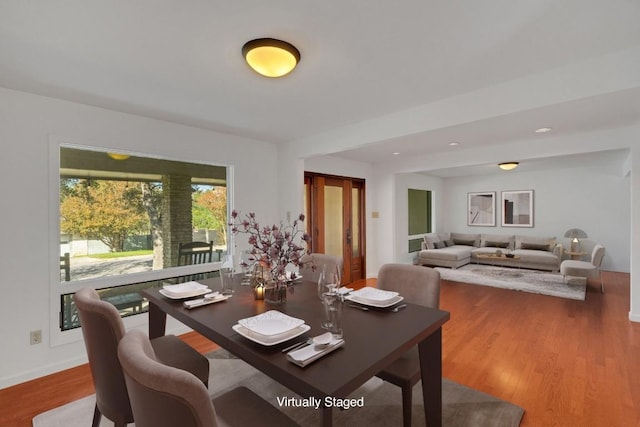 dining space with hardwood / wood-style floors