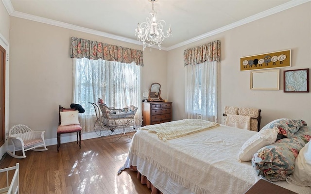 bedroom with hardwood / wood-style flooring, ornamental molding, and an inviting chandelier