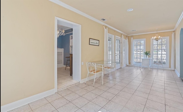 empty room with a chandelier, ornamental molding, and light tile patterned flooring