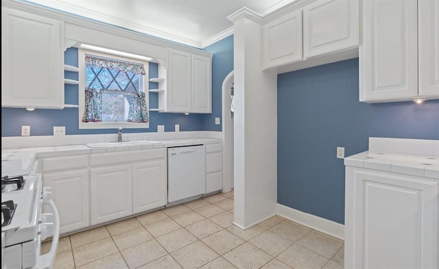 kitchen featuring tile countertops, dishwasher, white cabinets, sink, and range