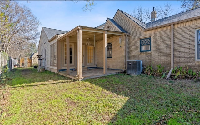 back of property featuring a yard, a patio, and central AC unit