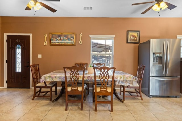 dining space with ceiling fan and light tile patterned floors