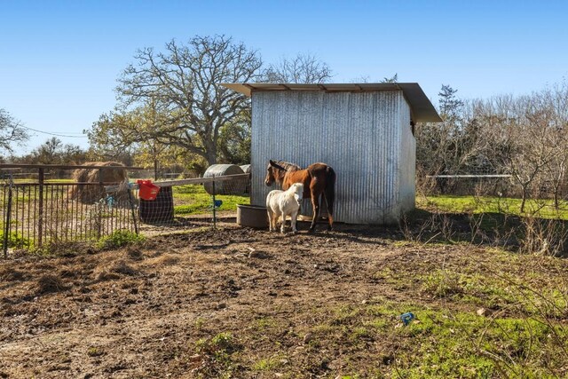 view of outdoor structure with a rural view