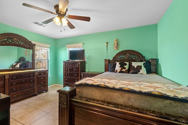 tiled bedroom with ceiling fan