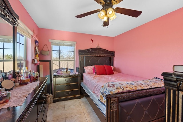 bedroom with ceiling fan and light tile patterned floors