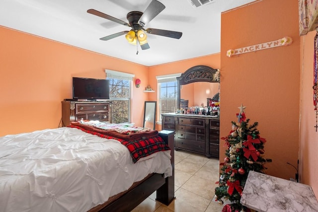 tiled bedroom featuring ceiling fan