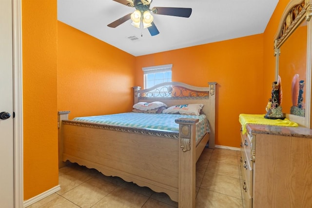 bedroom with ceiling fan and light tile patterned floors