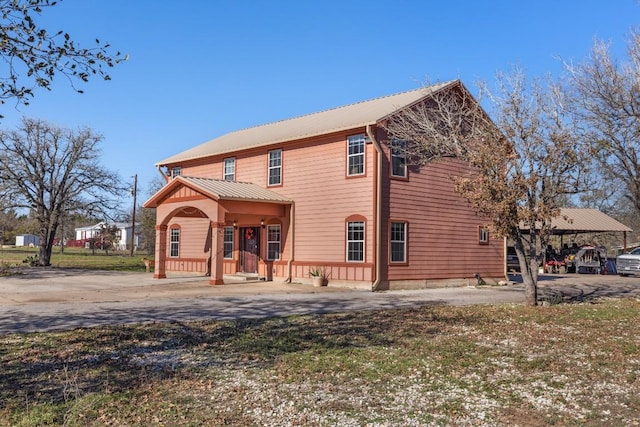 455 High View Ranch Dr, Cedar Creek, TX 78612 - rear view of property with a porch, driveway, and a metal roof