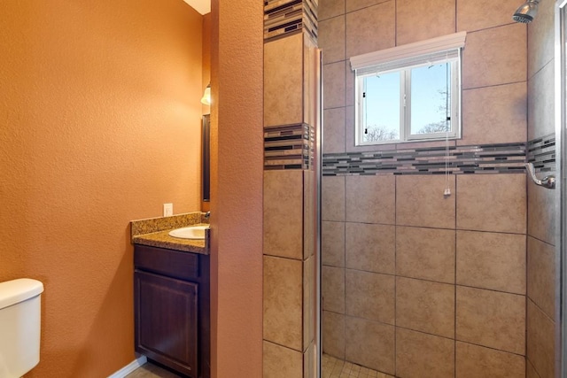 bathroom featuring vanity, toilet, and walk in shower