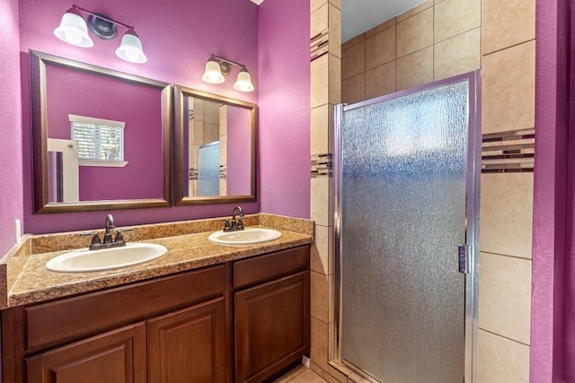 bathroom featuring vanity and a shower with shower door