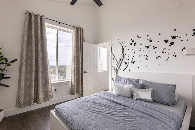 bedroom with ceiling fan and dark hardwood / wood-style floors