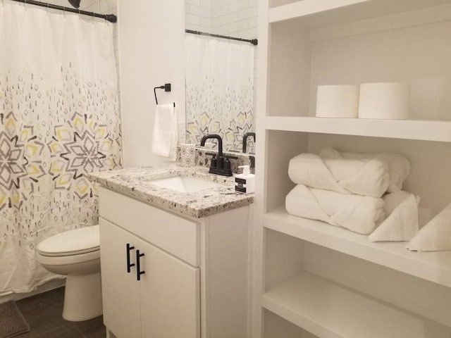 bathroom featuring backsplash, vanity, and toilet