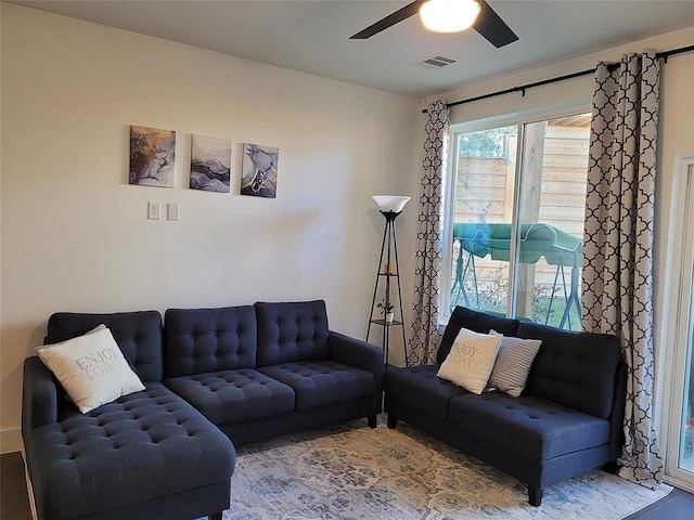 living room with hardwood / wood-style floors and ceiling fan