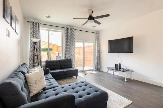 living room featuring hardwood / wood-style flooring and ceiling fan