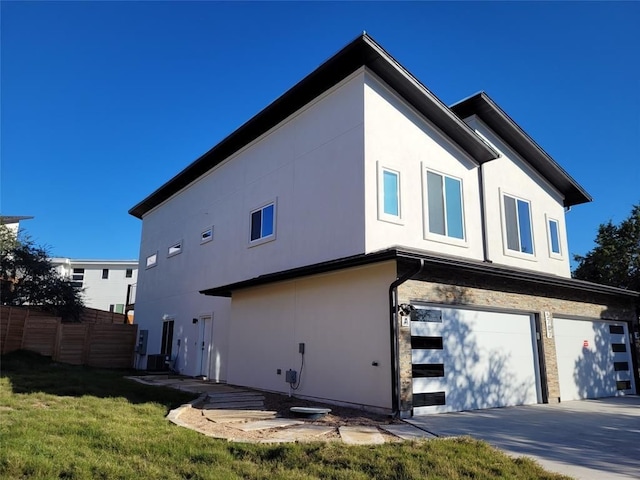 back of property with a yard and a garage